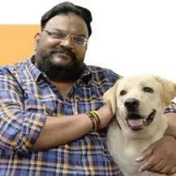 Rajh V Iyer co founder of Wiggles India with a light colored Labrador dog